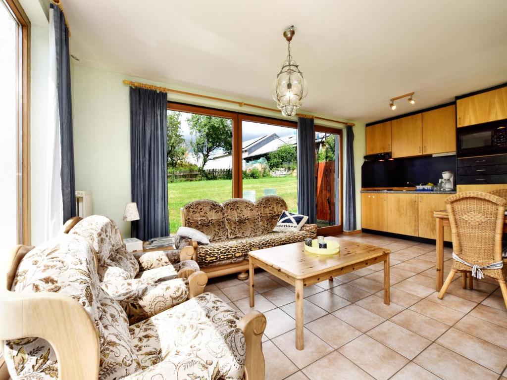 a living room with a couch and a table at Holiday Home in St Vith with hot tub in Amelscheid