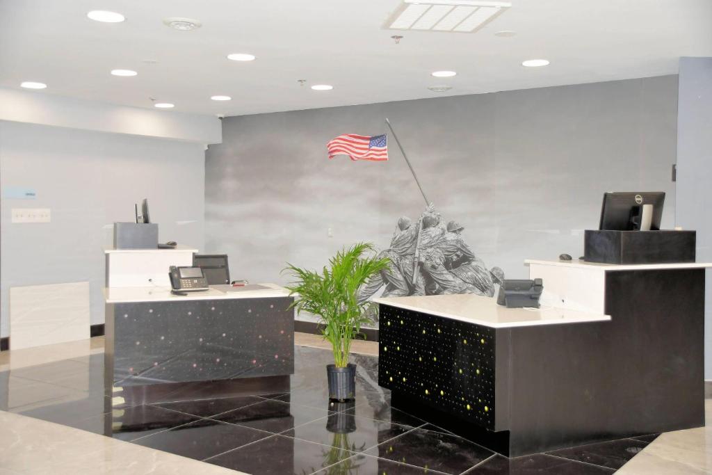 an office with an american flag on the wall at Clarion Pointe Jacksonville near Camp Lejeune in Jacksonville