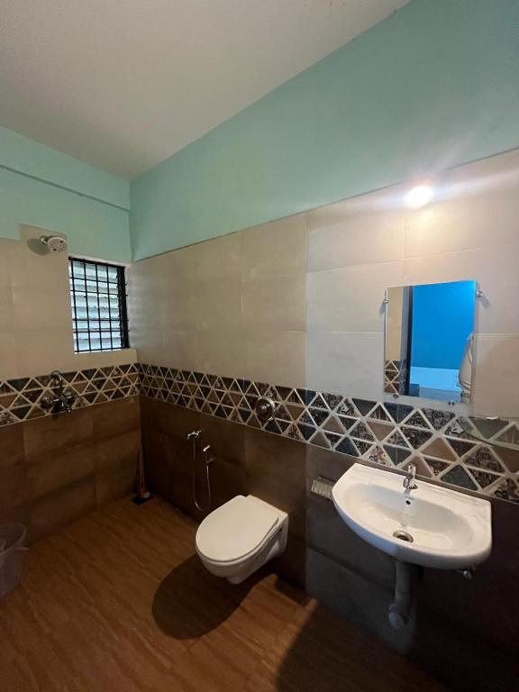 a bathroom with a toilet and a sink at The Boss House in Arambol