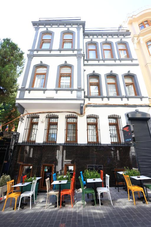 a group of tables and chairs in front of a building at New House Hotel in Istanbul