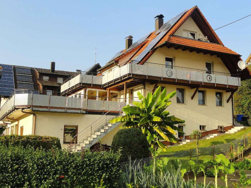 a large white house with a roof at Sonnenterrasse in Elzach