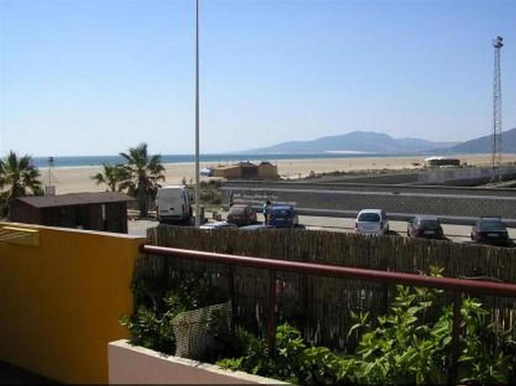 a view of a highway with cars parked on the beach at Apartamento Maria Angeles in Tarifa