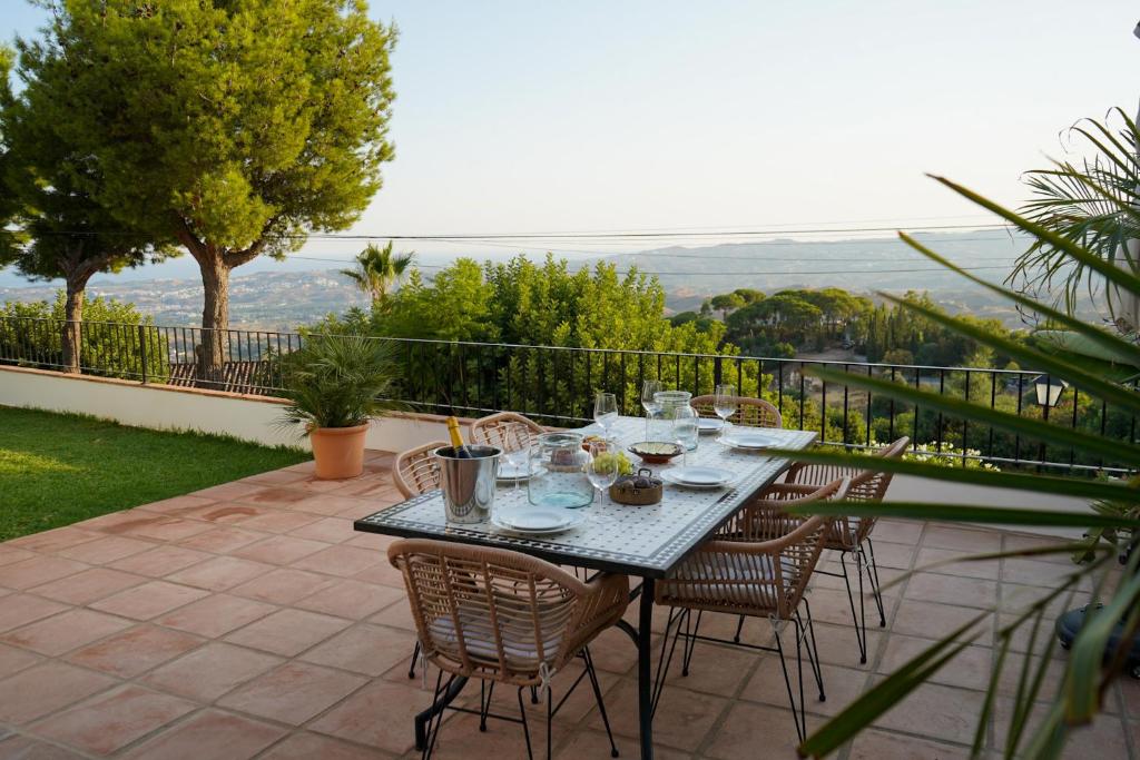 a table and chairs on a patio with a view at Casa El Cholo, Mijas Hideaway in Mijas