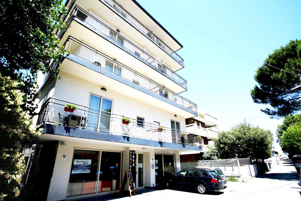 a building with a car parked in front of it at Residence Igea in Rimini