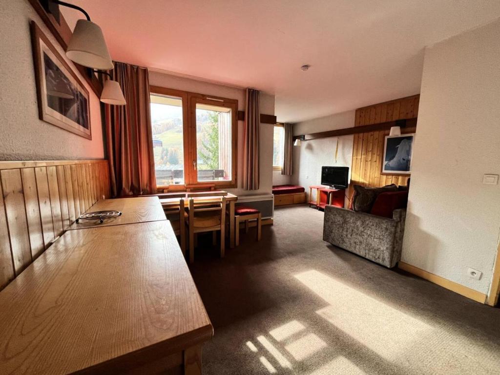 a room with a living room with a table and a couch at Résidence Eperviere - Résidence EPERVIERE n°640 MAE-5563 in Plagne 1800