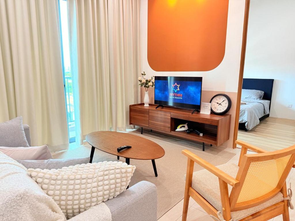 a living room with a couch and a tv at Jeff & Ricky Homestay143-Kenny Hiil Residence in Kuching