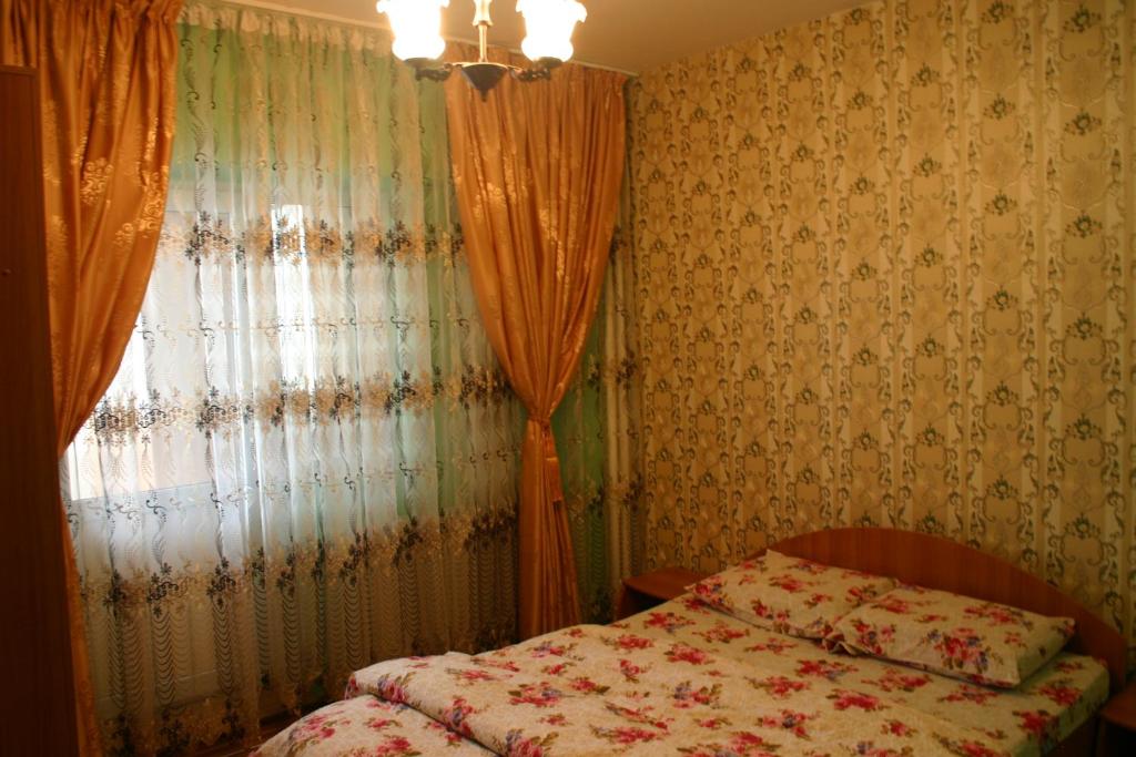 a bedroom with a bed in front of a window at Apartament Ultra central Style in Bacău