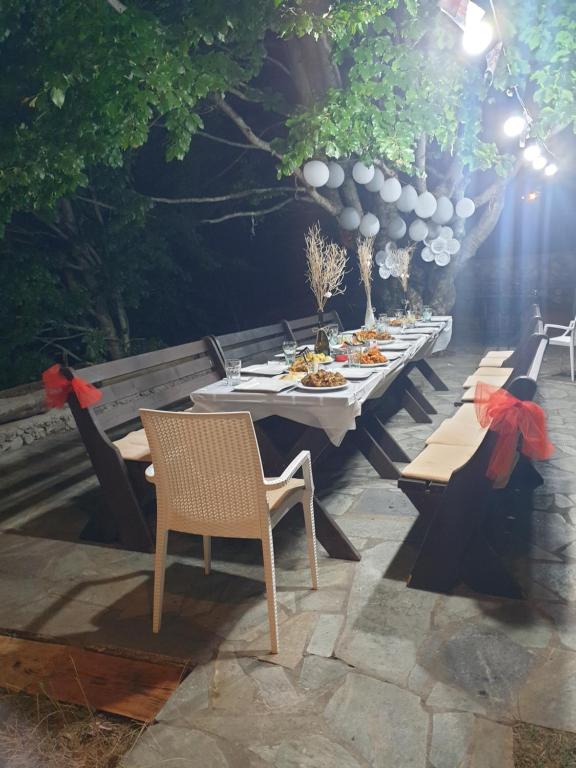 eine Gruppe von Tischen und Stühlen auf einer Terrasse in der Unterkunft Vila Harxhaj 3 in Razëm