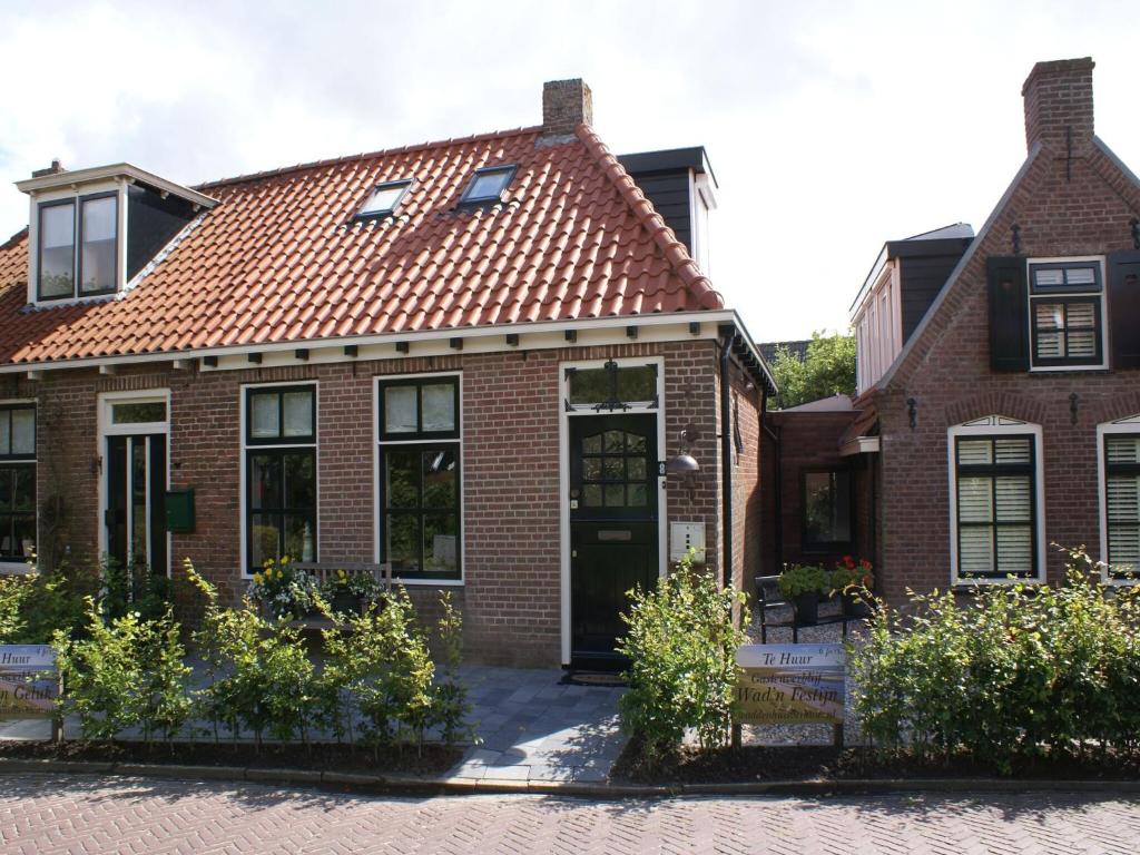 a brick house with a red roof at Fantastic luxury vacation home and next to the Wadden Sea in Paesens