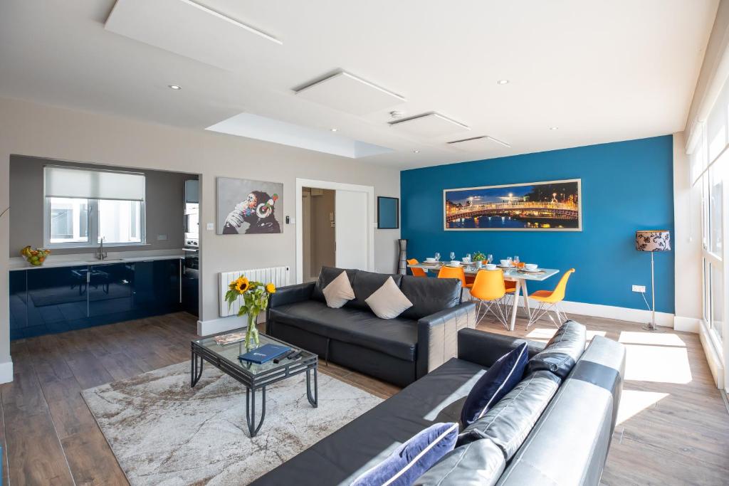 a living room with a couch and a table at Temple Bar Crown Square Apartments in Dublin