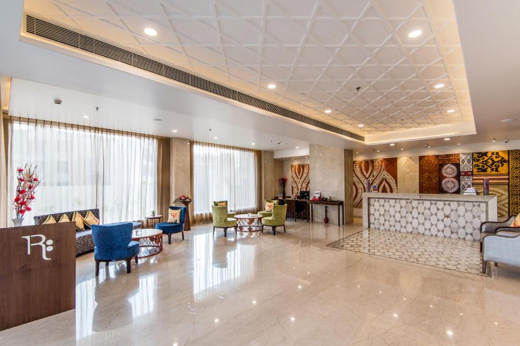 a lobby of a hotel with chairs and tables at Regenta Central Jaipur in Jaipur
