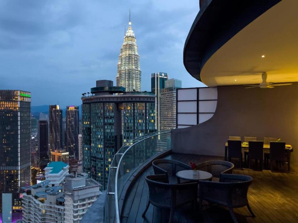 a room with a view of a city skyline at The Luxury Penthouse KLCC in Kuala Lumpur