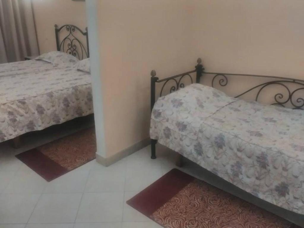 Postel nebo postele na pokoji v ubytování Ariha Hotel