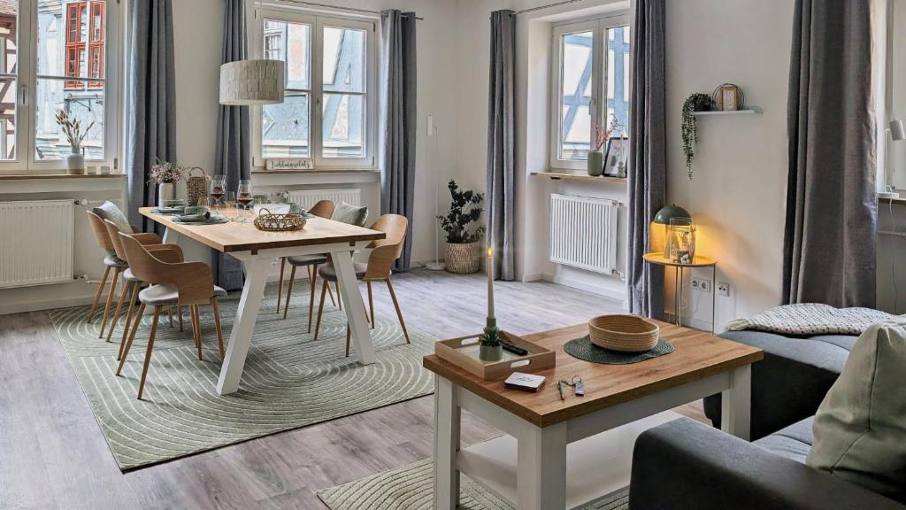 a living room with a table and a couch at Altstadtzauber Apartments Miltenberg in Miltenberg