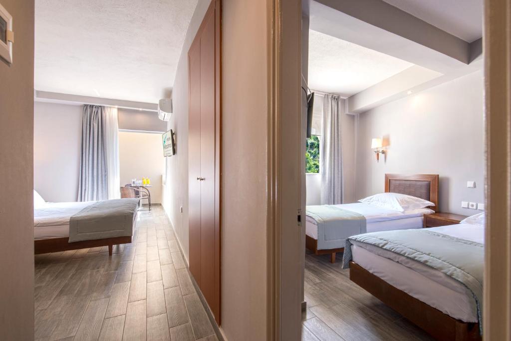 A bed or beds in a room at Albatros Hotel