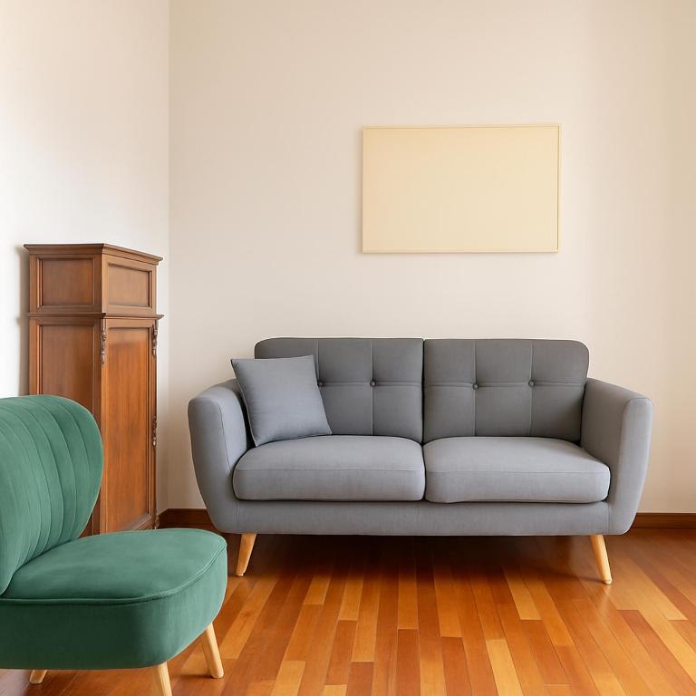 a living room with a couch and a chair at Residenza del Capitano in Siena