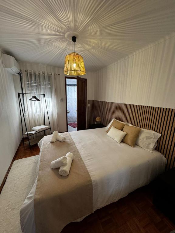 a bedroom with a large bed with towels on it at Casa da Vila in Vila Franca do Campo