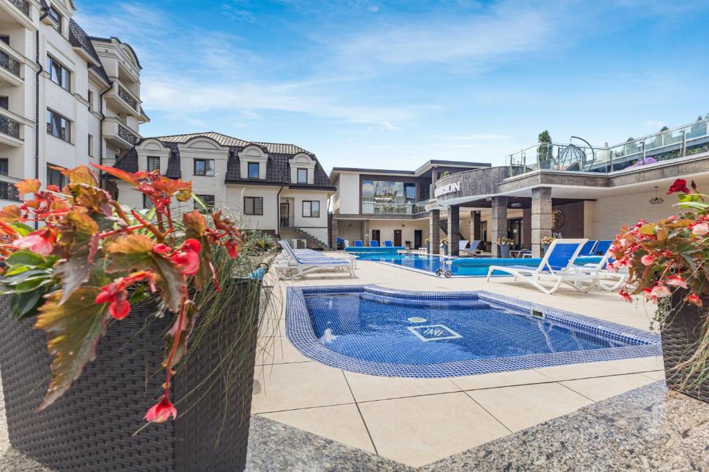 an exterior view of a house with a swimming pool at MARION SPA Hotel in Bukovel