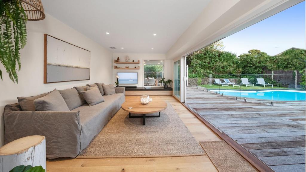 a living room with a couch and a pool at Casa del Sol Heated Pool & Spa in Sorrento