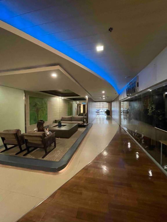 a living room with a couch and a table in a building at Antel Spa Residences 9A in Manila