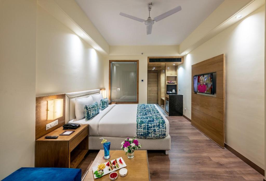 a hotel room with a bed and a table at New Kanha Hotel in Jaipur