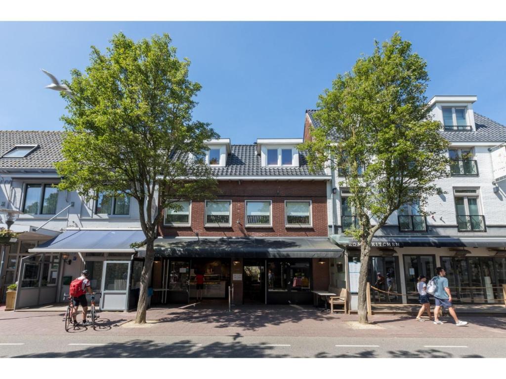 people walking on a street in front of a building at Central Domburg Apartment in Domburg