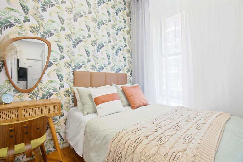 a bedroom with a bed and a mirror at Upscale 2BR Home in New York