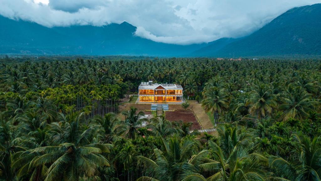 an aerial view of a house in a banana plantation at Punya Farms - Luxury 5BR near Isha Yoga in Alāndurai