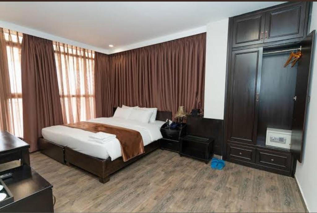 a hotel room with a bed and a desk at Bonita Boutique Hotel Q5 in Ho Chi Minh City