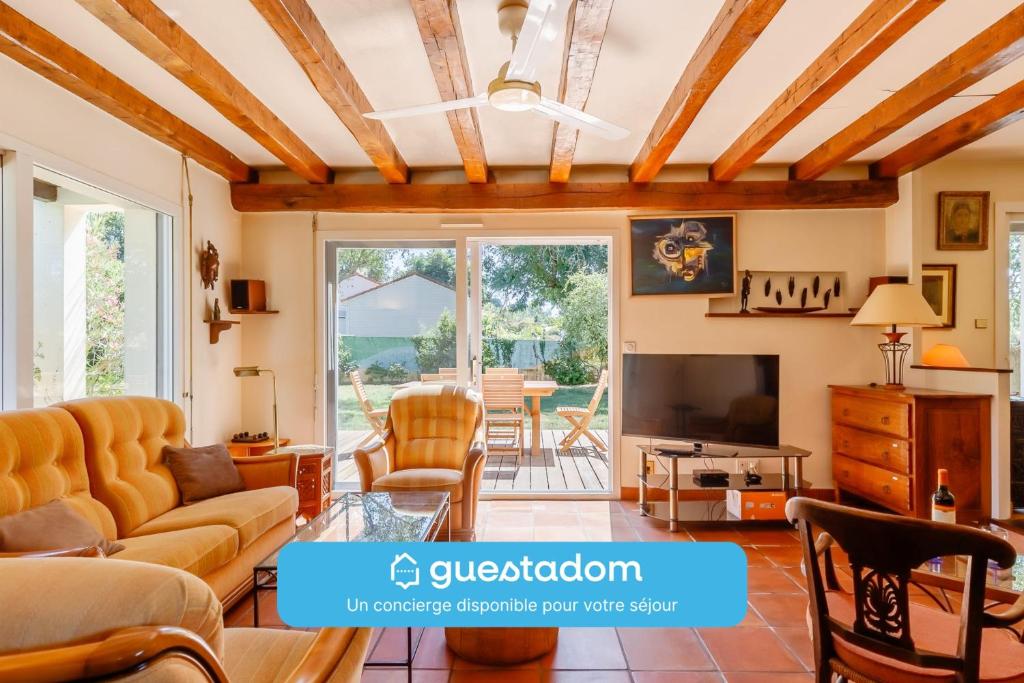 a living room with a couch and a tv at Chez Paddy - Familial - Paisible in Challans