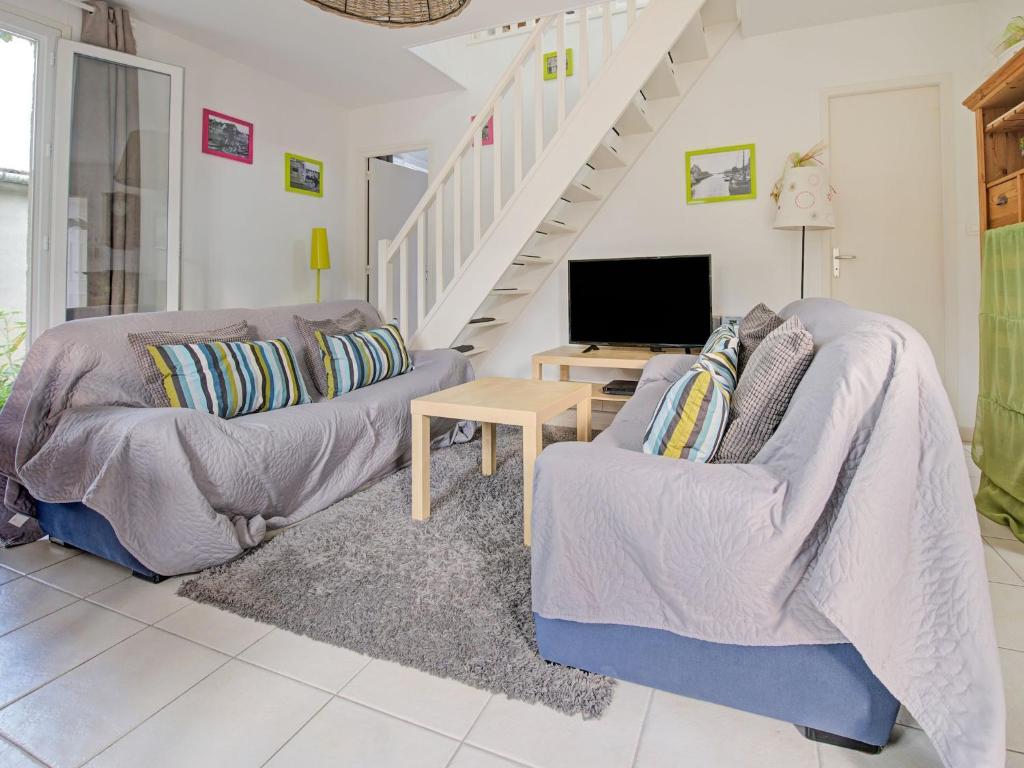 a living room with two couches and a tv at Harbor Haven in Isigny-sur-Mer in Isigny-sur-Mer