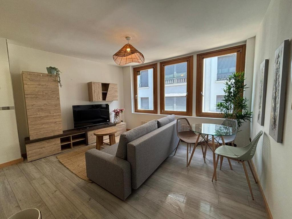 a living room with a couch and a table at Atuairehome Plaza Mayor II con Parking Incluido in Burgos