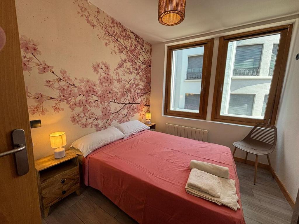 Un dormitorio con una cama roja y una pared con flores en Atuairehome Plaza Mayor II con Parking Incluido, en Burgos