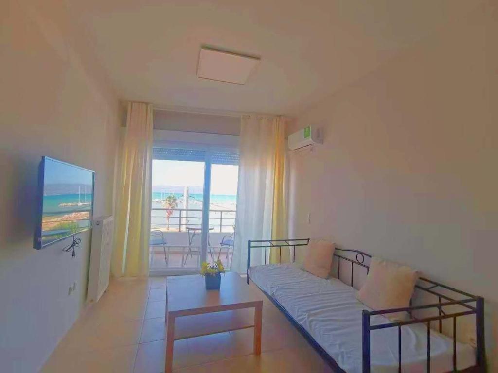 a living room with a couch and a view of the ocean at Thalassa View c2 in Khalkoútsion