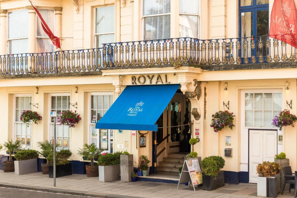 a building with a blue awning in front of it at Royal Hotel in Scarborough