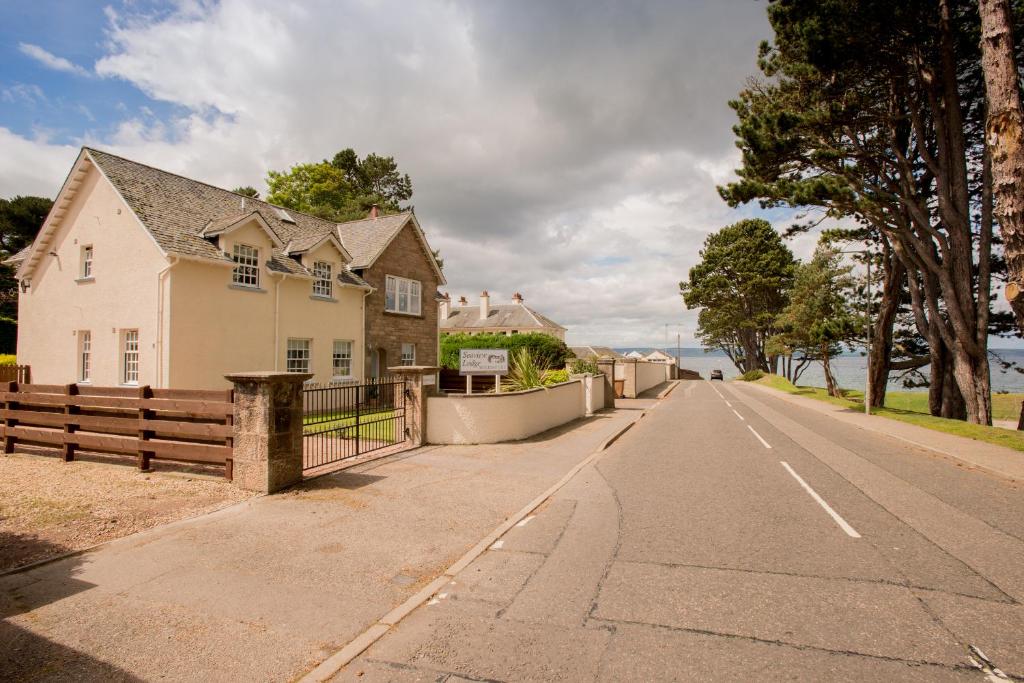 a house on the side of a road at Sea View Lodge in Nairn