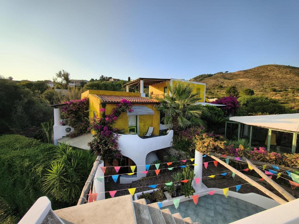 a house with colorful flags in front of it at Casa Gialla B&B in Lipari