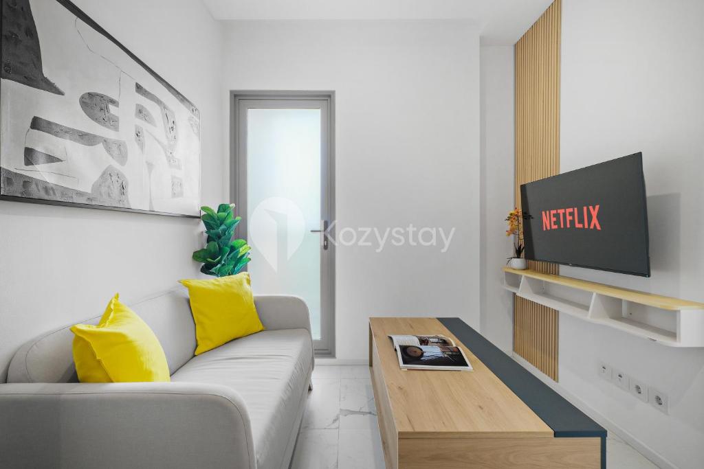 a living room with a couch and a table at Soreli by Kozystay - TB Simatupang in Jakarta