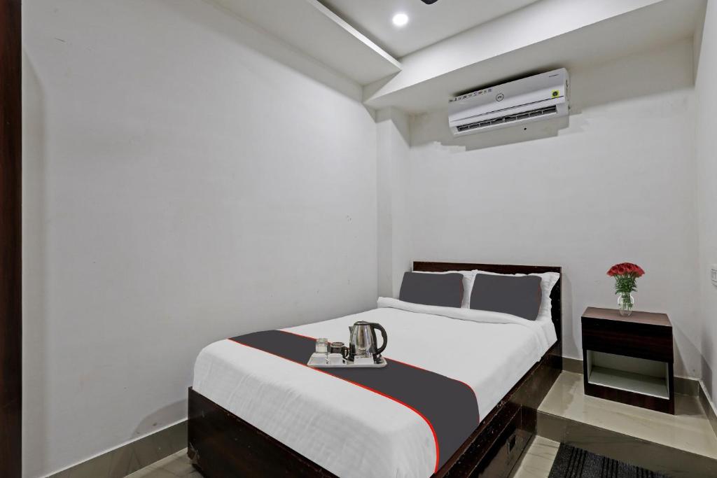 una camera bianca con letto e lavandino di Collection O Rani Gate Guwahati Formerly Lakhi Guest House a Guwahati