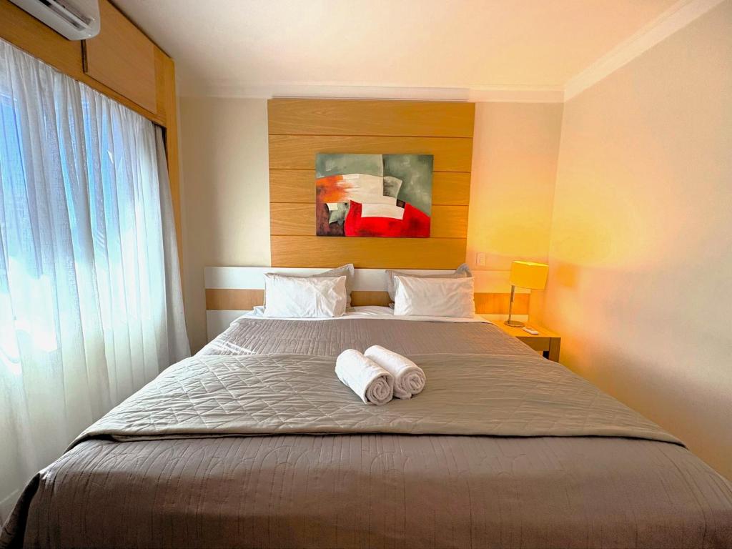 a bedroom with a bed with two towels on it at H714- Congonhas Hotel Flat in São Paulo