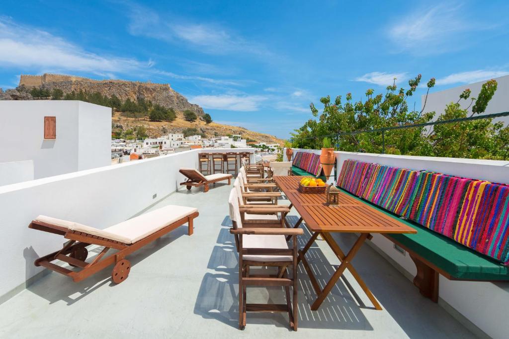 a row of tables and chairs on a roof at Villa Eftihia in Lindos in Líndos