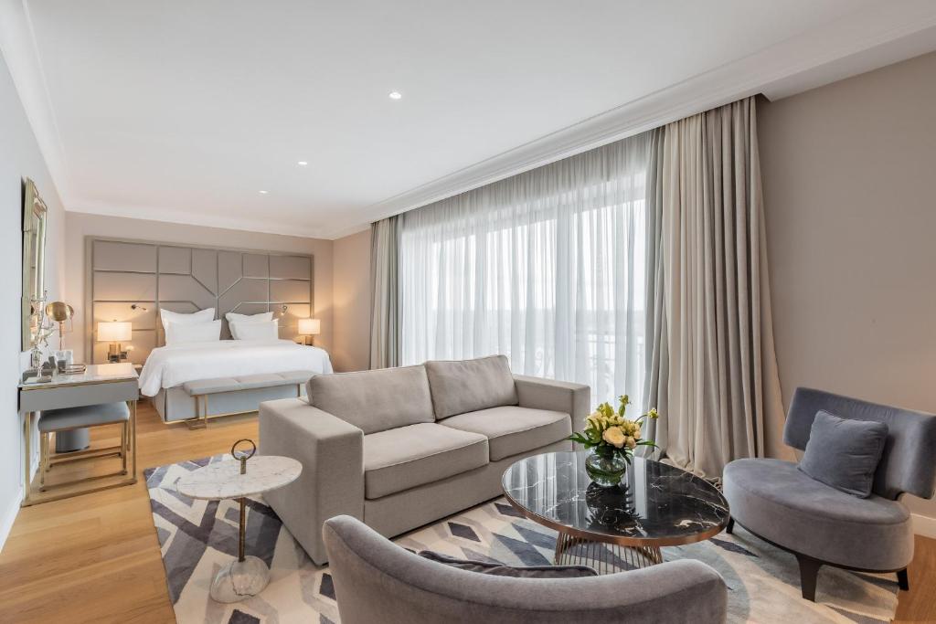 a living room with a couch and a bed at Edem Kyiv in Kozin