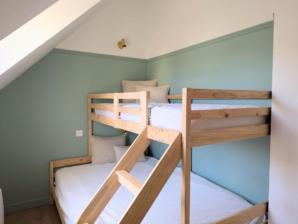 a bunk bed room with two bunk beds in a house at Maison Dahouët en bord de mer- Grand Jardin clos in Pléneuf-Val-André