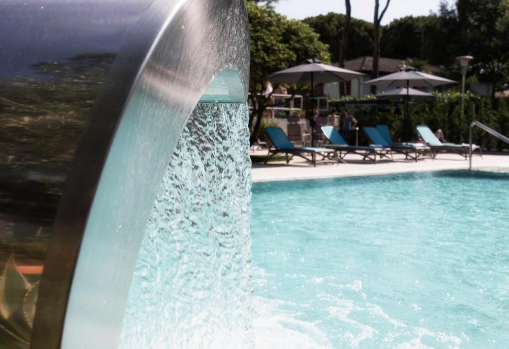a water fountain in a swimming pool at Hotel Arizona in Lignano Sabbiadoro