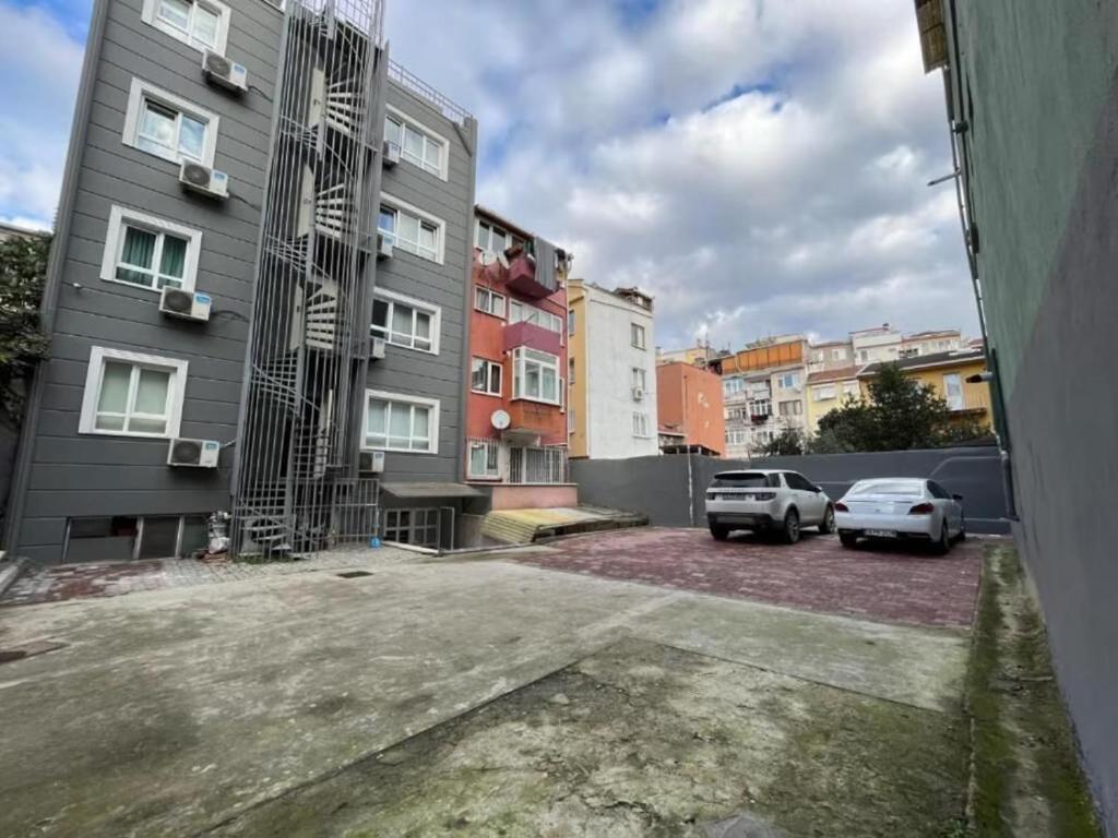 a parking lot with two cars parked in front of buildings at Elite Marmara Bosphorus & Suites in Istanbul