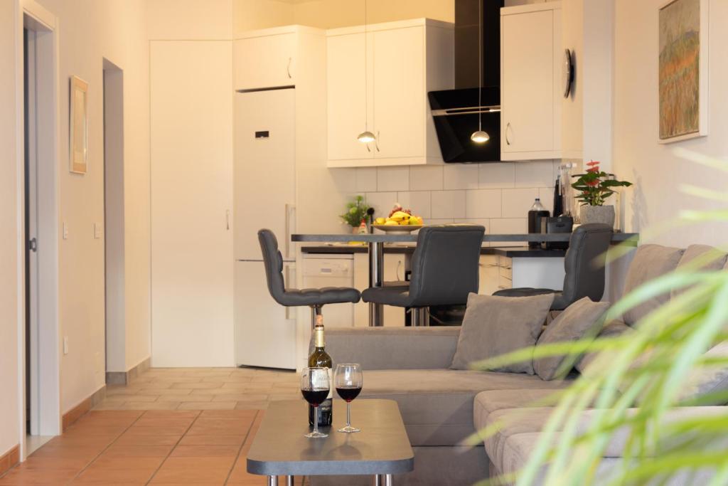 a living room with a couch and a table with wine glasses at Infinity View in La Matanza de Acentejo