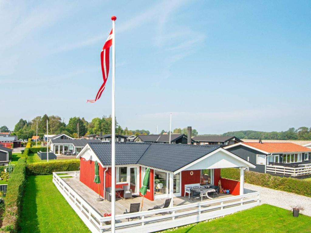 a house with a flag in front of it at 6 person holiday home in Juelsminde-By Traum in Sønderby