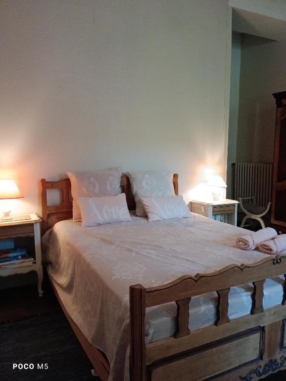 a bedroom with a large bed with white sheets and pillows at Artbnb in Lézat-sur-Lèze