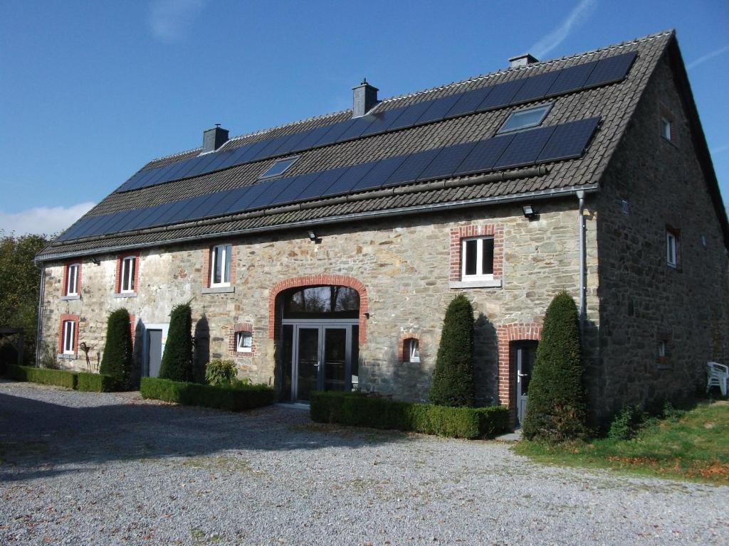 a large brick building with solar panels on it at Holiday Home with Sauna in Sourbrodt in Waimes