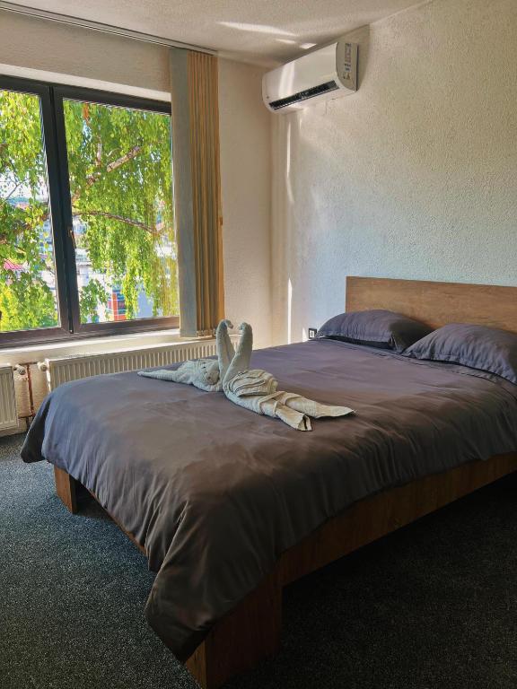 a bed with a animal laying on top of it at Apartman Alinac in Cazin